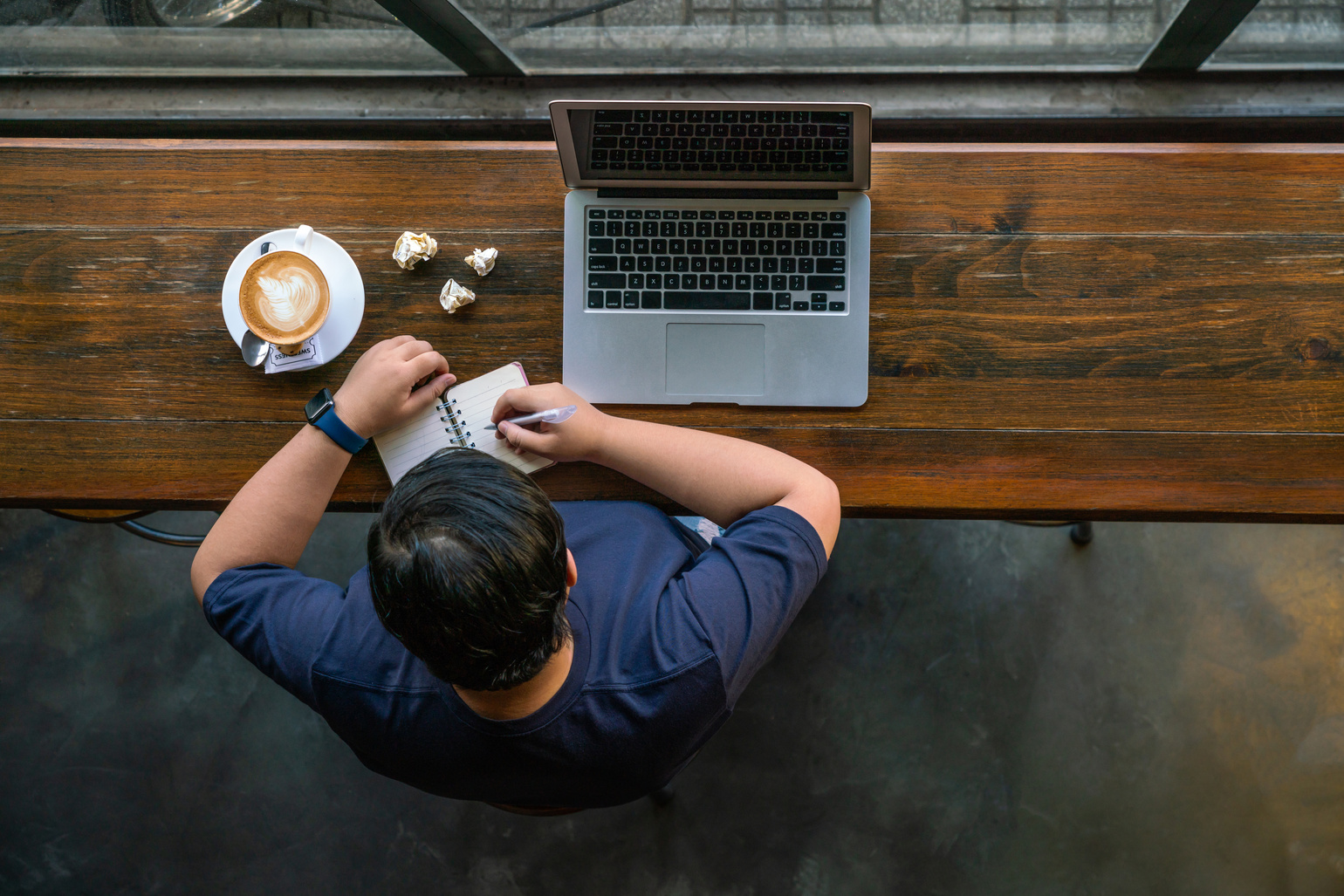 Asian woman writing notes about marketing content